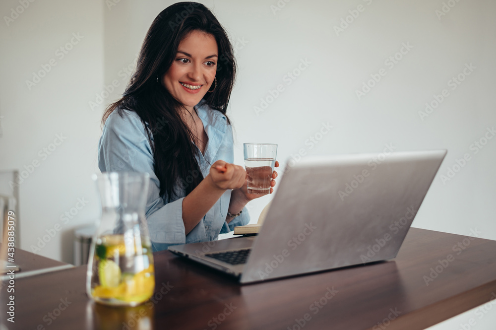 Young attractive businesswoman using a laptop while working in her office Young attractive businesswoman using a laptop while working in her office