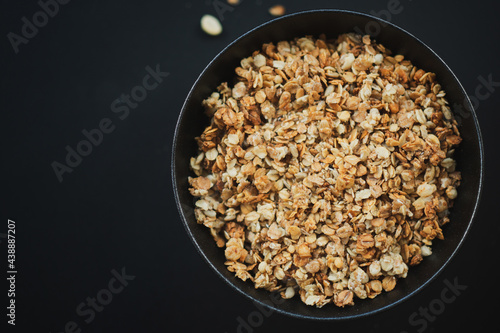 Homemade granola in bowl on dark
