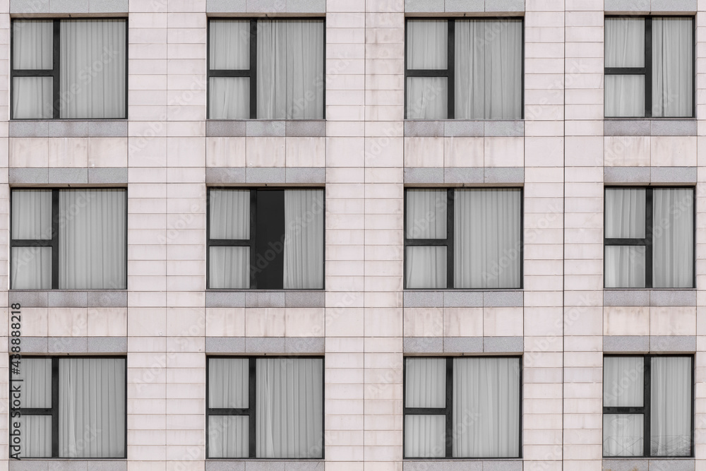 White marble granite facade and multiple windows closed White marble granite facade and multiple windows closed