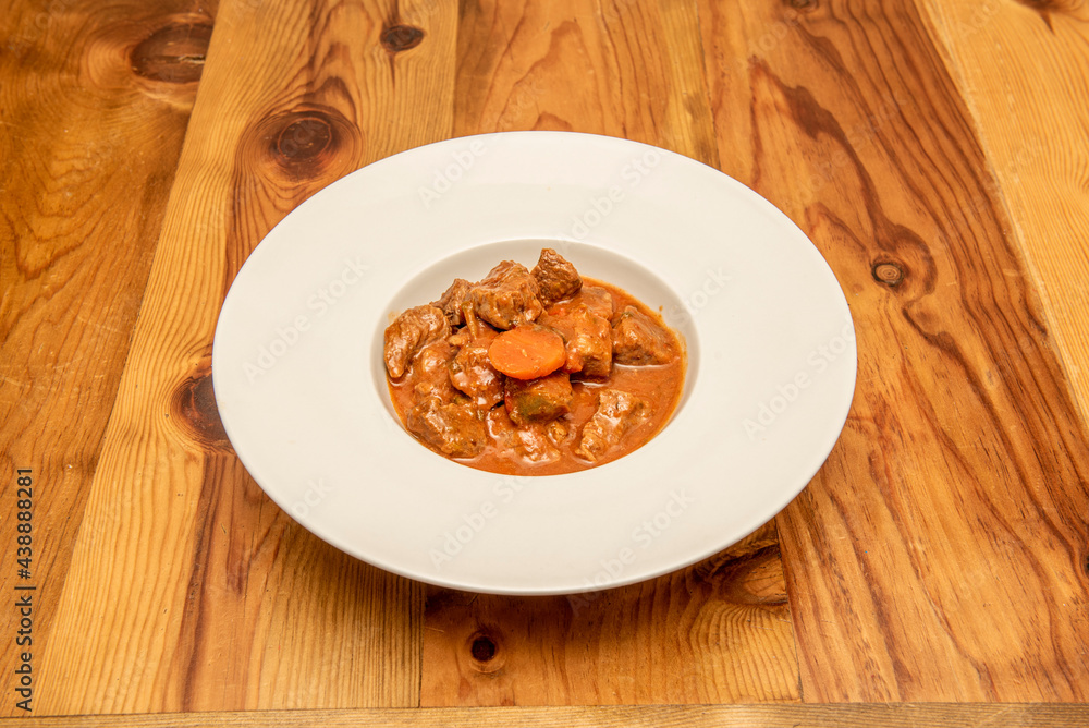 Plate of stewed beef ragu with vegetables Plate of stewed beef ragu with vegetables