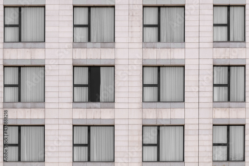 White marble granite facade and multiple windows closed