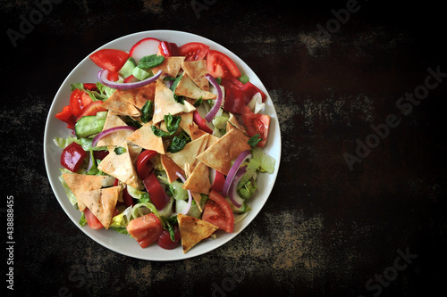 Fattoush salad on plates. Middle Eastern cuisine. Famous Arabic salad with pita bread.