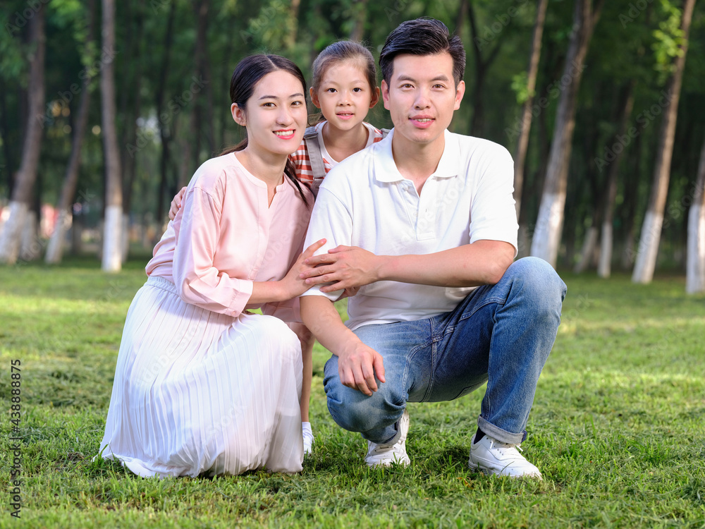 Happy family of three playing in the park Happy family of three playing in the park