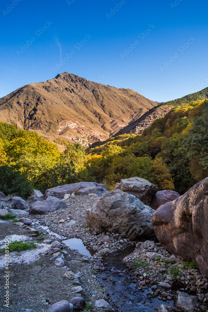 View in canyon and road leading towards Jebel Toubkal highest mountain peaks of High Atlas mountains in Toubkal national park, Morocco, North Africa