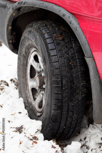 Car tire buried in the snow. © lapis2380