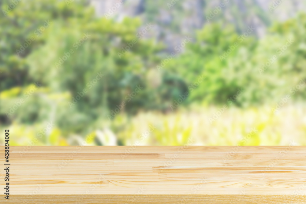 wood table top on blur plants and mountains background wood table top on blur plants and mountains background