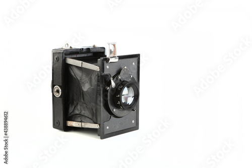 Old pre war large format scaling camera on white background.