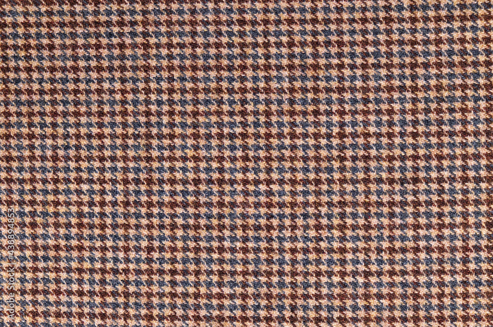 Brown tweed fabric. Woolen textile background Brown tweed fabric. Woolen textile background