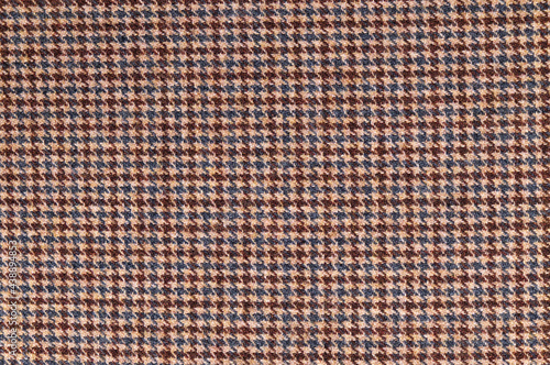 Brown tweed fabric. Woolen textile background