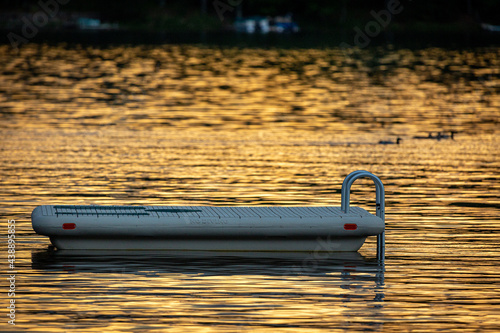 Lake swimming float under a sunset on a lake in Wisconsin 