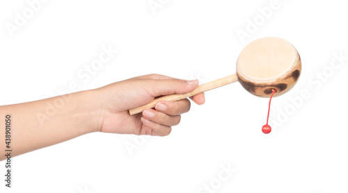 hand holding Denden daiko folk art toy isolated on a white background photo