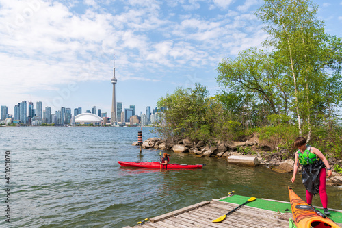 Setting out sea kayaking from a dock on Centre Island in Toronto, with the downtown city skyline in the background. 
