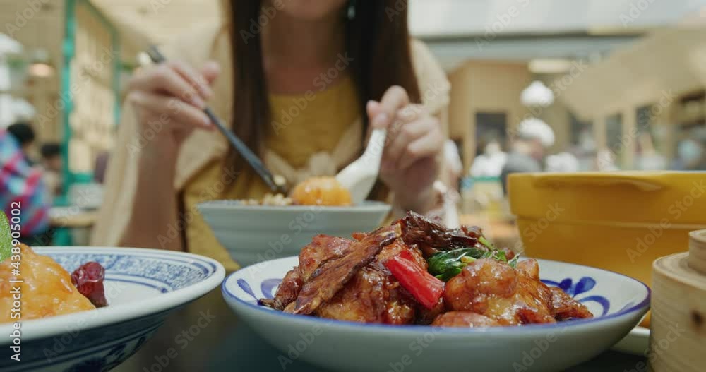 Woman having meal in Chinese style restaurant Woman having meal in Chinese style restaurant