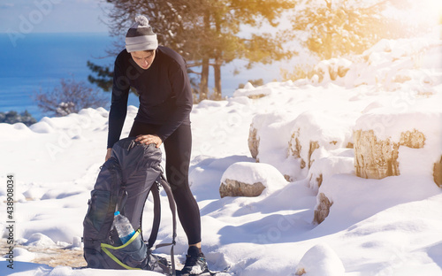 фотографія A young man in merino wool thermal underwear comfortably climbs the mountains in winter