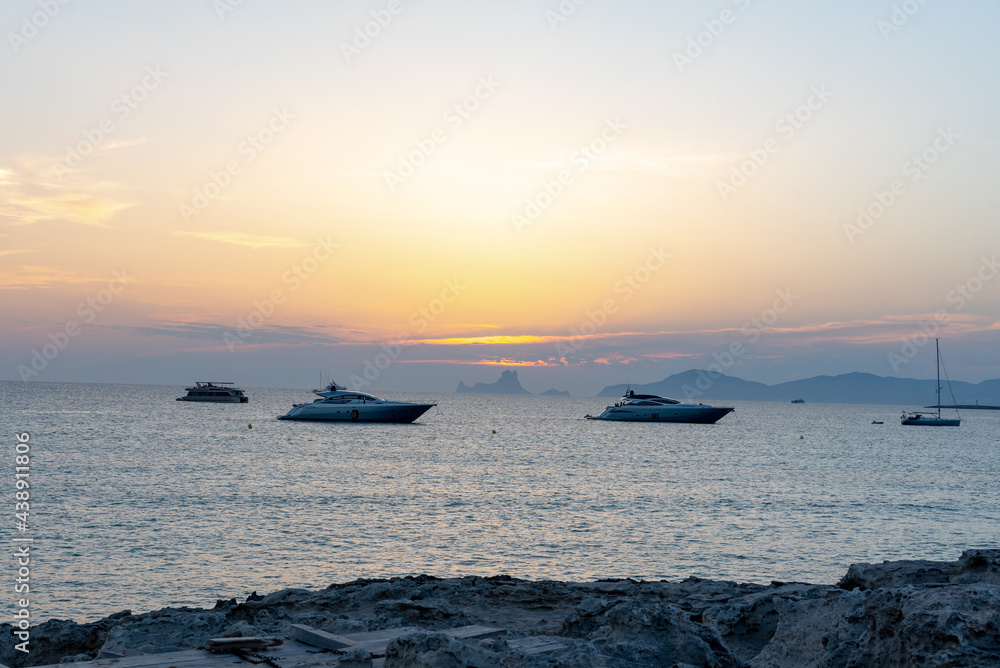  Boats in  the Wonderful sunset on the beach of Ses Illetes on the Island of Formentera in Spain.