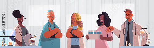 team of medical professionals mix race doctors in uniform working together in laboratory medicine healthcare