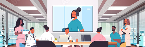 team of doctors having video conference mix race medical professionals discussing at round table medicine healthcare