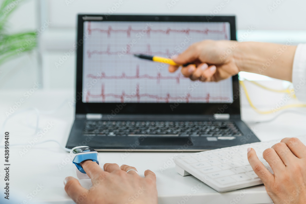 Biofeedback Training Session. Monitoring Heart Rate, Therapist Explaining Patterns to a Biofeedback Client Biofeedback Training Session. Monitoring Heart Rate, Therapist Explaining Patterns to a Biofeedback Client
