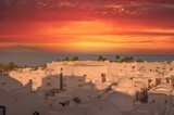 fabulous mysterious white old arab city under the red dramatic sky sunset. Aerial view. roofs and domes of an ancient arab city