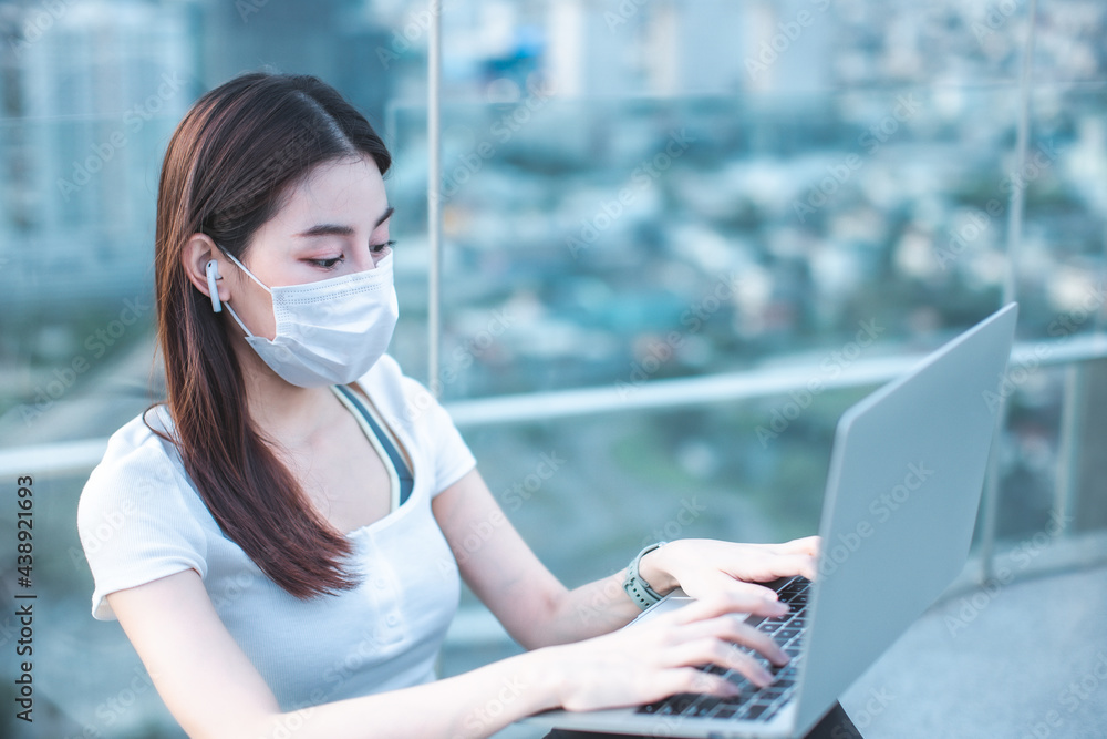 Portrait of smiling pretty young woman using notebook on rooftop city bangkok.Female using mobile phone make vlog and live in social media . Portrait of smiling pretty young woman using notebook on rooftop city bangkok.Female using mobile phone make vlog and live in social media .