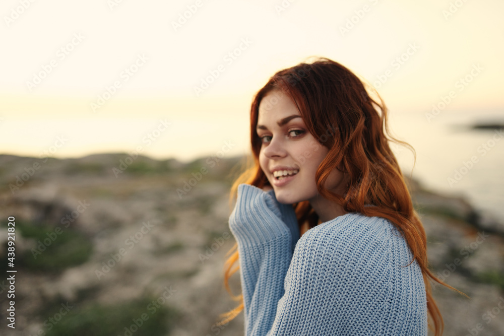 cheerful woman in a blue sweater outdoors sunset travel vacation cheerful woman in a blue sweater outdoors sunset travel vacation