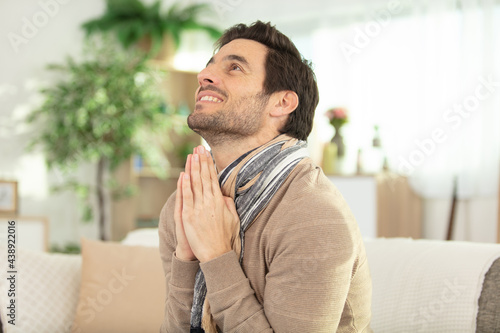 man thinking and praying at home