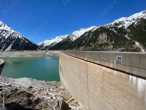 Staudamm Stausee Schlegeisspeicher nahe Mayrhofen Tux in den Tuxer Alpen Tirol Zillertal bei Niedrigwasser im Mai  photo