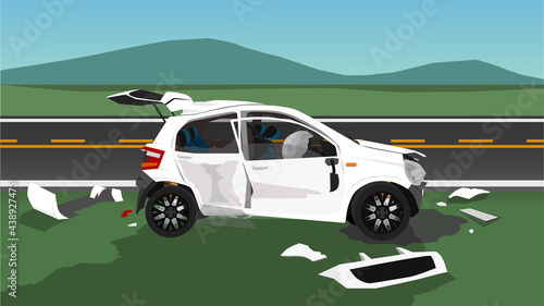 Accident of white hatchback car is damaged on all sides. Parked on the roadside. Fragments scattered all over the floor. Engine oil leaks onto the floor. wide open meadows and mountains background