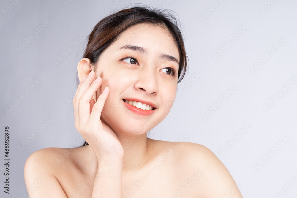 Beautiful young asian woman with clean fresh skin on white background,