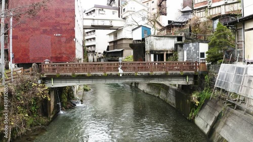 Drone shot moving between buildings in countryside of japan.