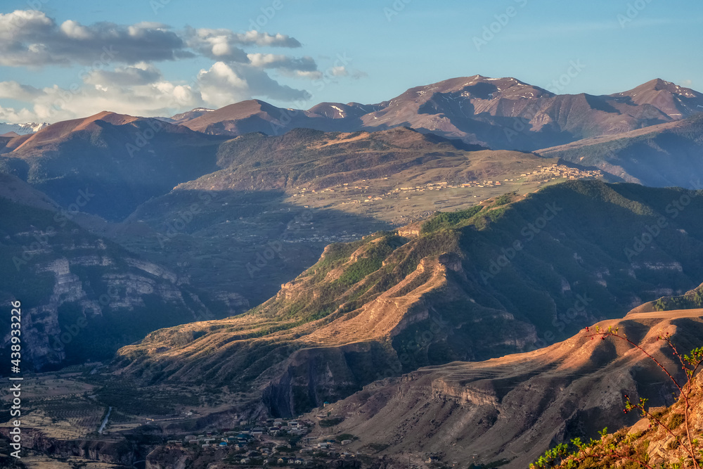 Fototapeta premium Caucasus mountains at dawn. Atmospheric landscape with silhouettes of mountains on background of pink dawn sky. Colorful nature scenery with sunset or sunrise. Sundown in faded tones.