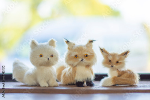 Fotografie A small dog doll on a wooden table