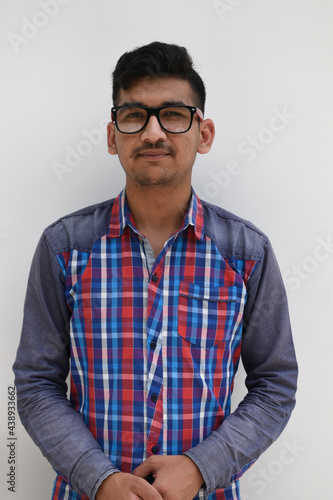 Indian nerd boy wearing eye spectacles looking at camera and hands folded in isolated white background