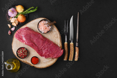 Overhead view of raw beef tri-tip roast with seasoning ready for cooking photo