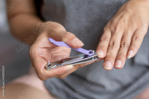 woman cutting nails with nail clippers Hygiene concept. 