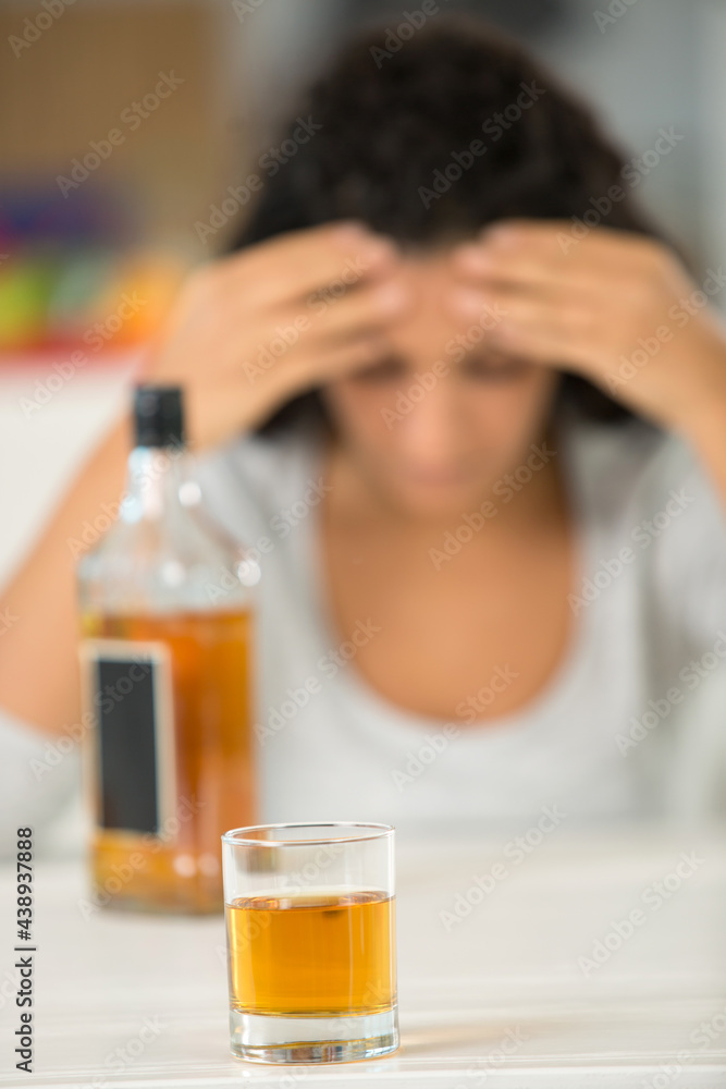 glass of liquor with woman on the background glass of liquor with woman on the background