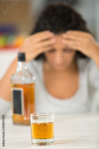 glass of liquor with woman on the background