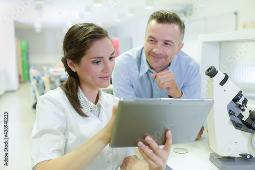 student showing digital tablet in lab classroom