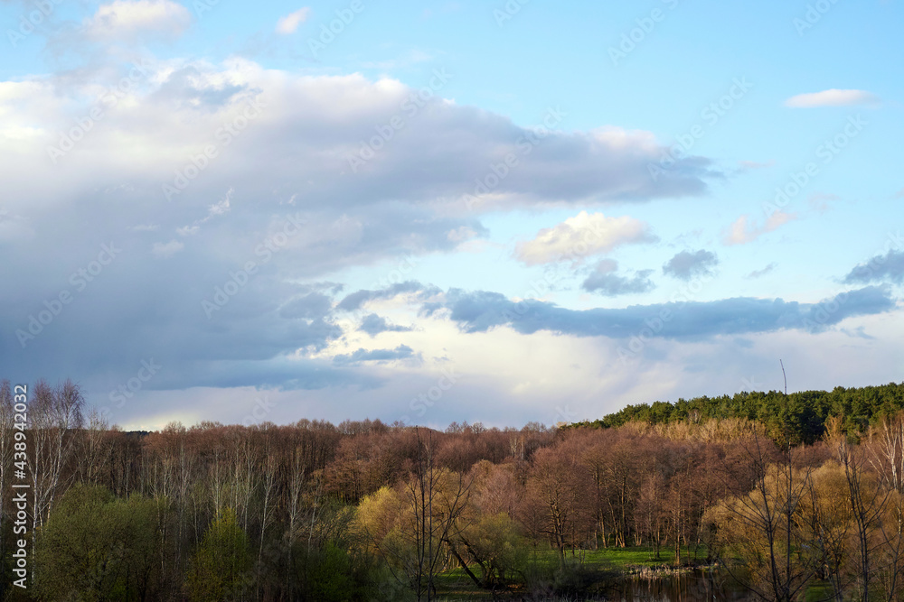 Spring landscape with beautiful sky, forest and river