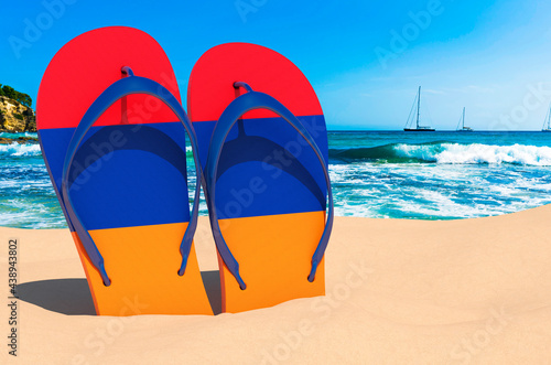 Flip flops with Armenian flag on the beach. Armenia resorts, vacation, tours, travel packages concept. 3D rendering