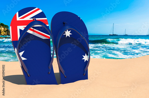 Flip flops with Australian flag on the beach. Australia resorts  vacation  tours  travel packages concept. 3D rendering