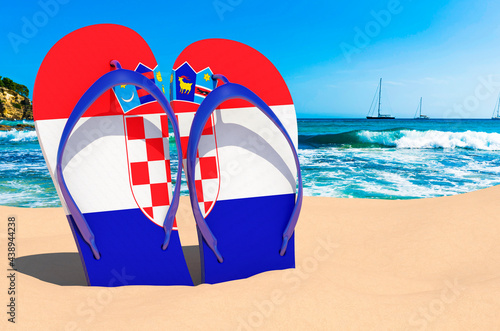 Flip flops with Croatian flag on the beach. Croatia resorts, vacation, tours, travel packages concept. 3D rendering