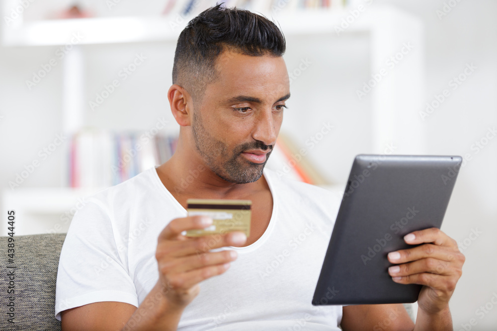portrait of cheerful man paying for order with credit card portrait of cheerful man paying for order with credit card