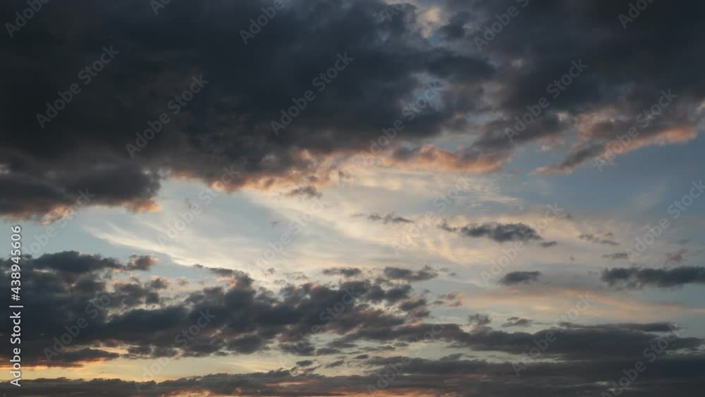 Dark gray, blue and pink clouds float through the sky at sunset, time lapse Dark gray, blue and pink clouds float through the sky at sunset, time lapse