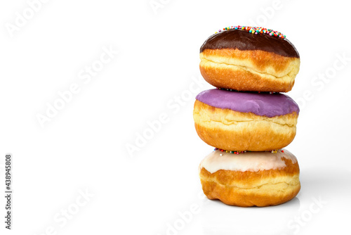 Three colorful donuts with glaze isolated on white background.
