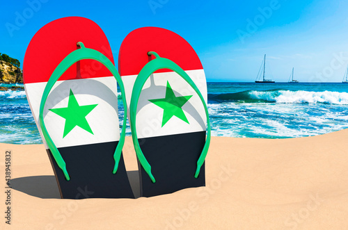 Flip flops with Syrian flag on the beach. Syria resorts, vacation, tours, travel packages concept. 3D rendering