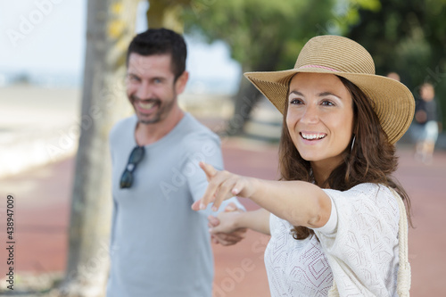 cheerful couple pointing at something