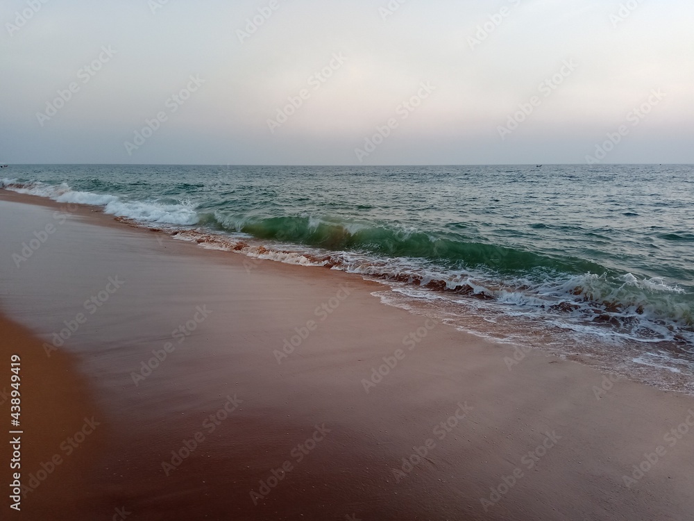 Beach at sunset with Red sand and Green waters