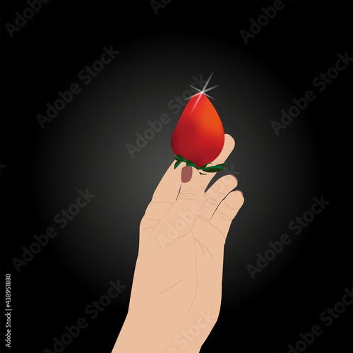 Woman hand holding fresh strawberry. hand holds strawberries on black.