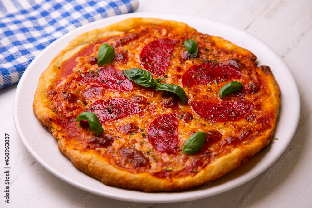 Pizza with salami. Traditional italian recipe.